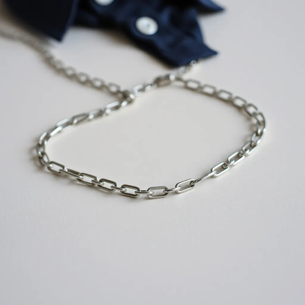 Silver chain necklace for men with crisp link detail on a light background and soft reflections