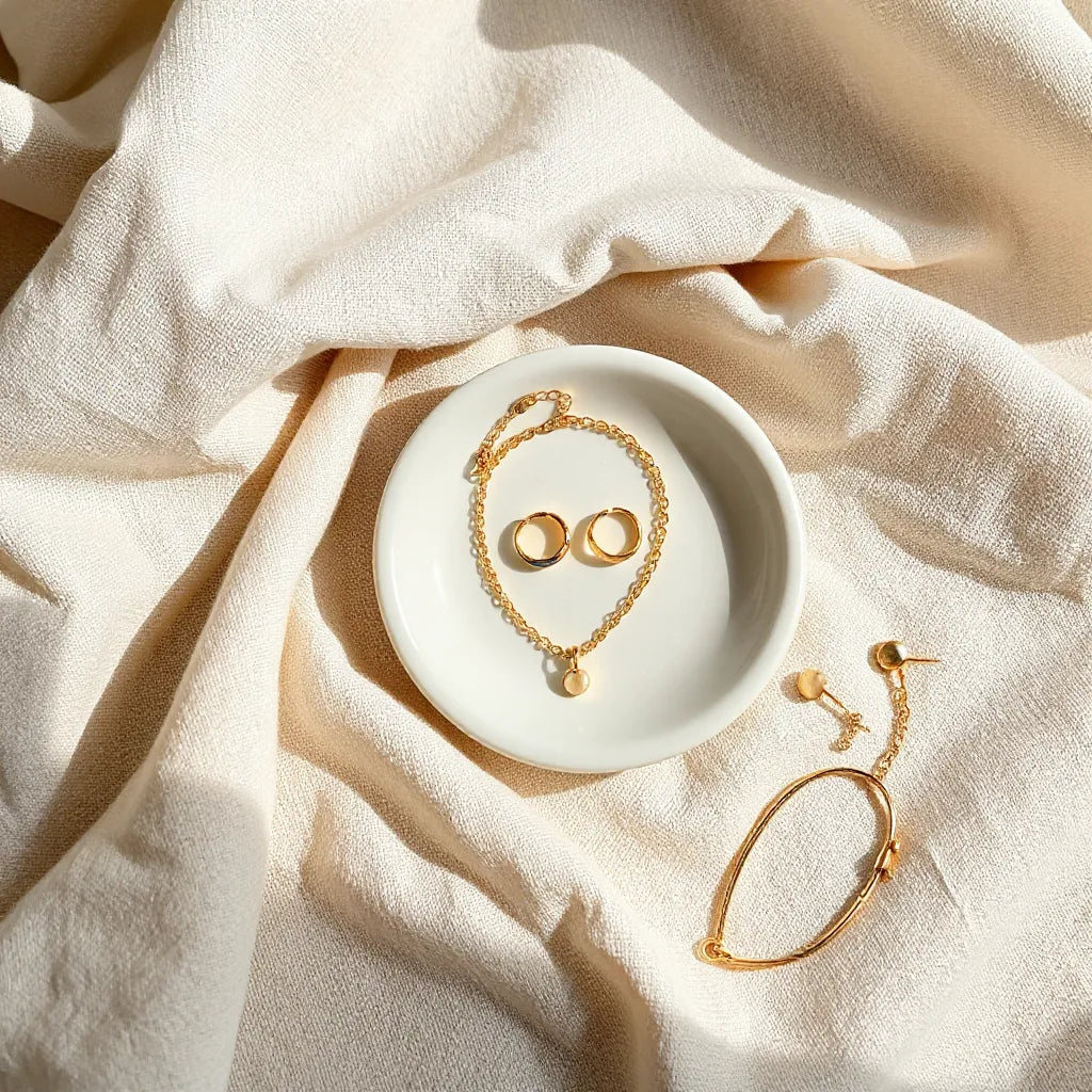 Handmade Italian jewelry pieces laid on neutral fabric in soft natural light