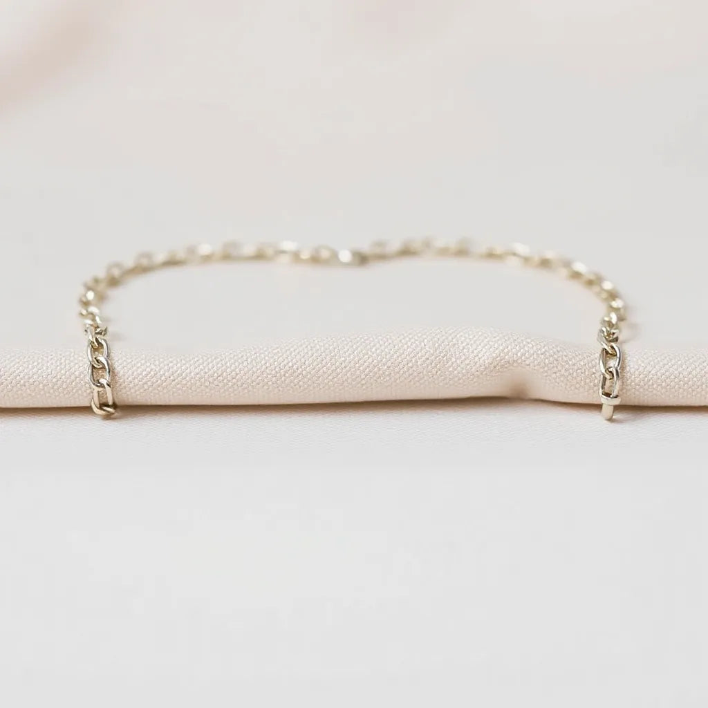 Polished franco chain necklace with clear link detail on a light neutral fabric surface