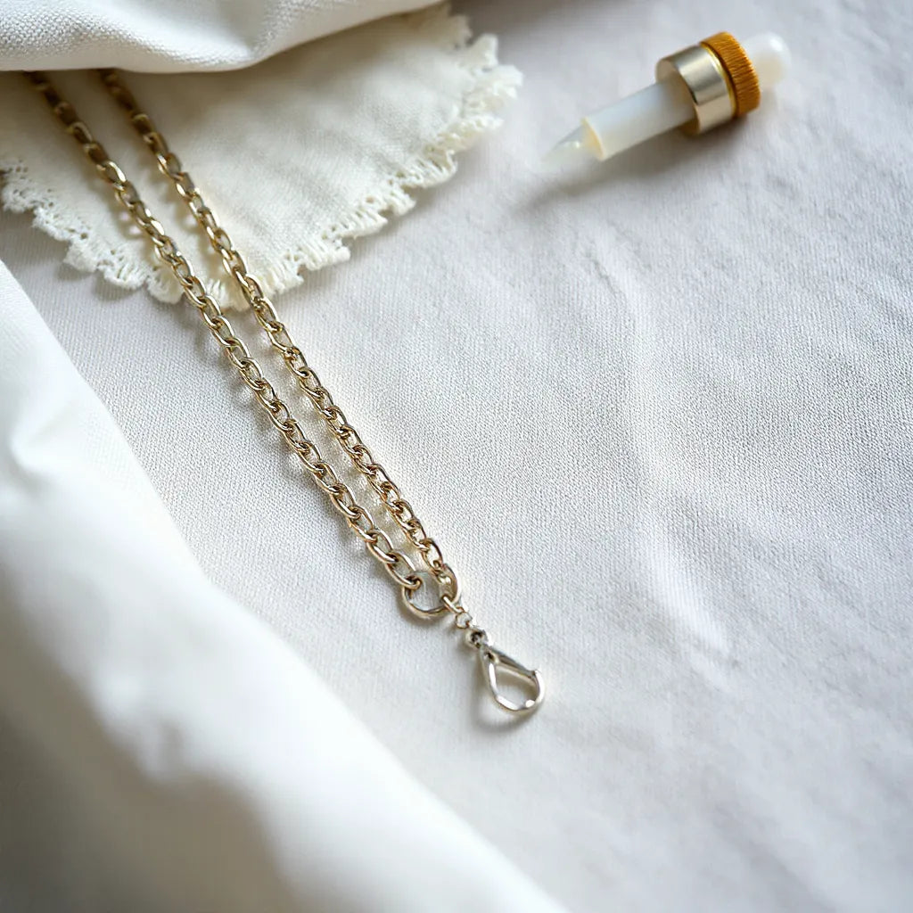 925 sterling silver chain with soft highlights and a polishing cloth on light fabric