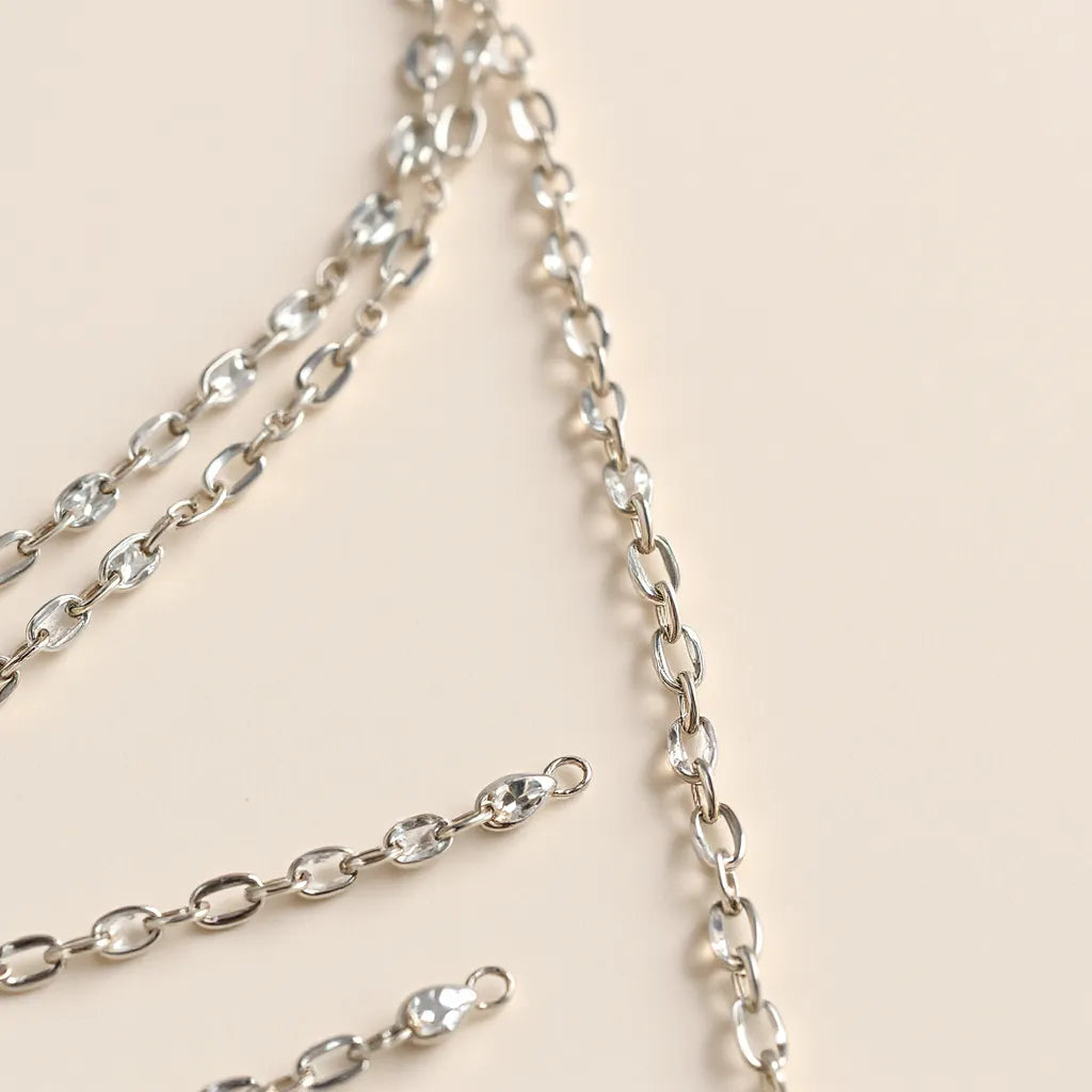 Shimmering diamond cut silver chains with crisp facets on a clean neutral background