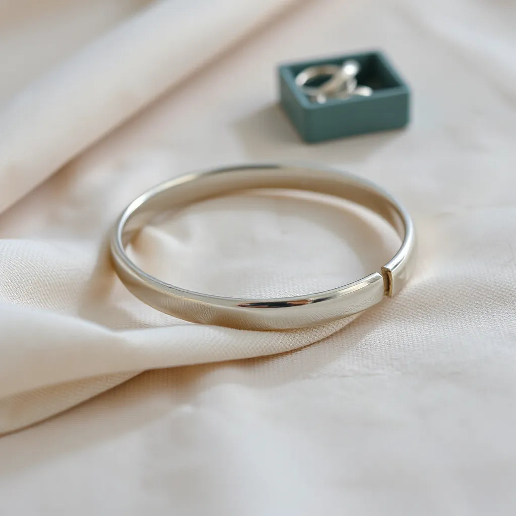 Classic sterling silver bracelet on neutral fabric with soft studio highlights