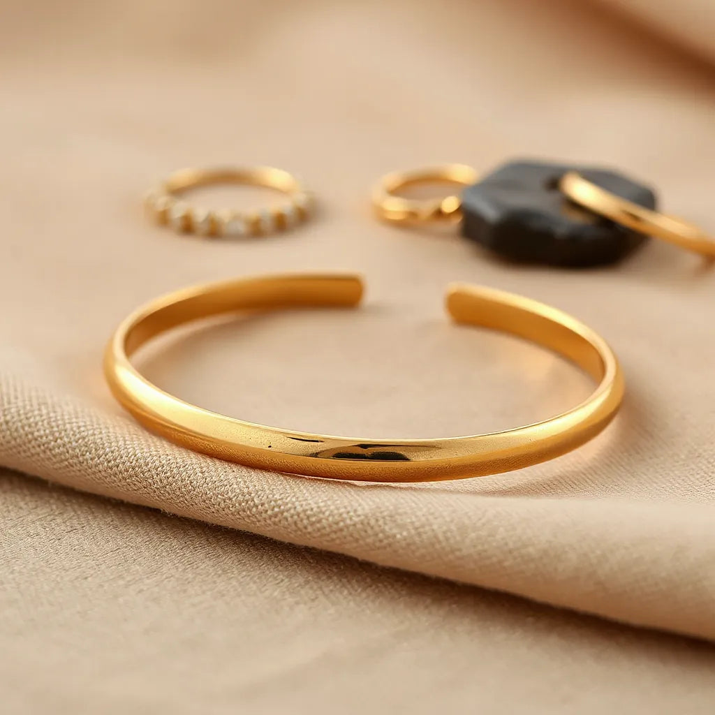 Gold vermeil bracelet with warm highlights on neutral fabric background