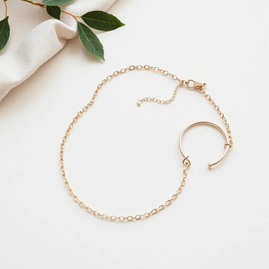 Figaro chain necklace and matching bracelet arranged neatly on a neutral fabric background