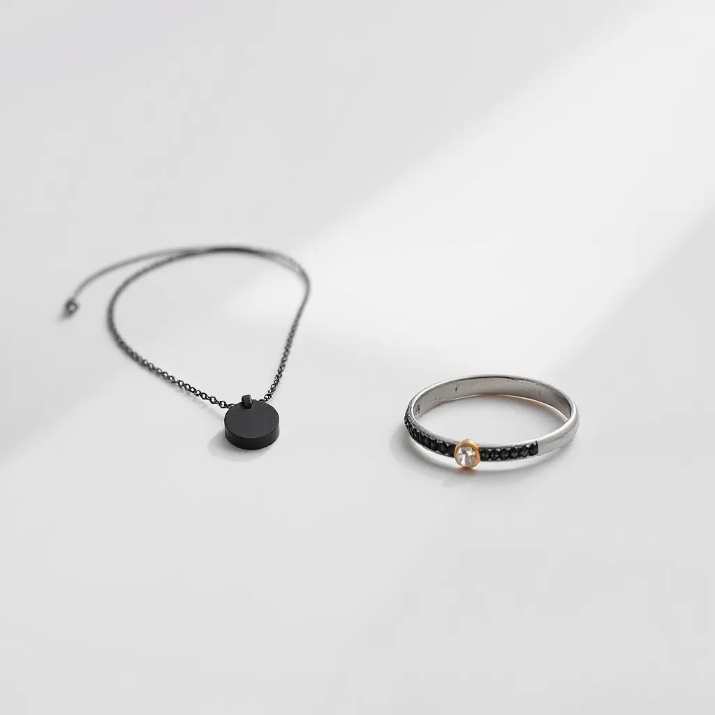 Minimalist unisex pendant necklace and bracelet arranged on a neutral surface with soft natural light