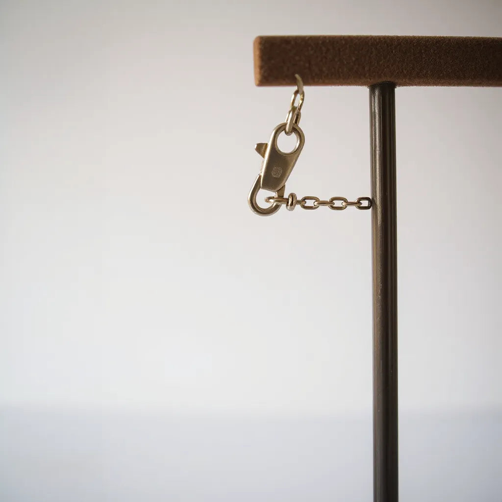 Lobster clasp on a jewelry chain securely latched with links clearly visible