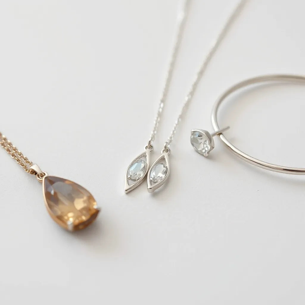 Polished 925 sterling silver necklace pendant, earrings, and bracelet on a clean light background