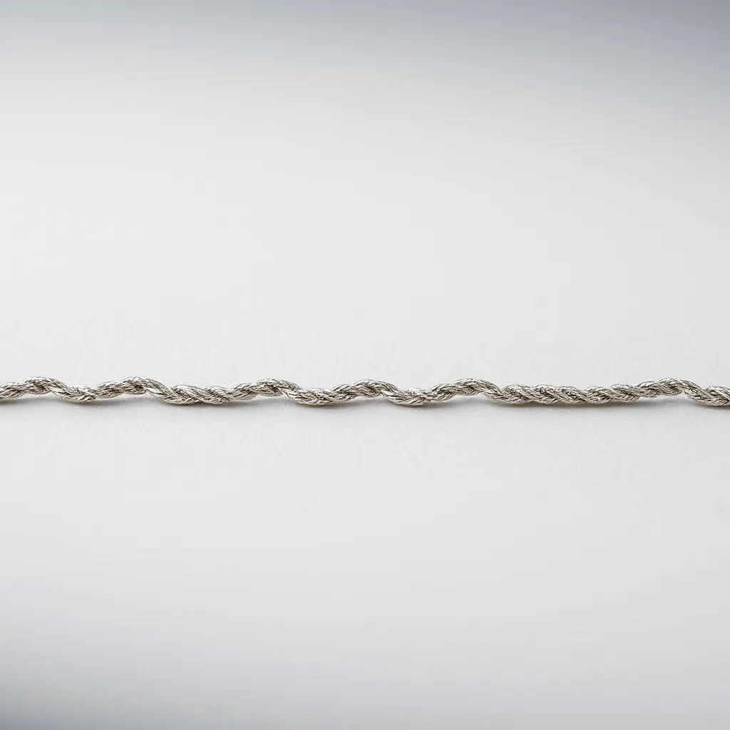 Polished silver rope chain necklace with detailed linked pattern on a light background