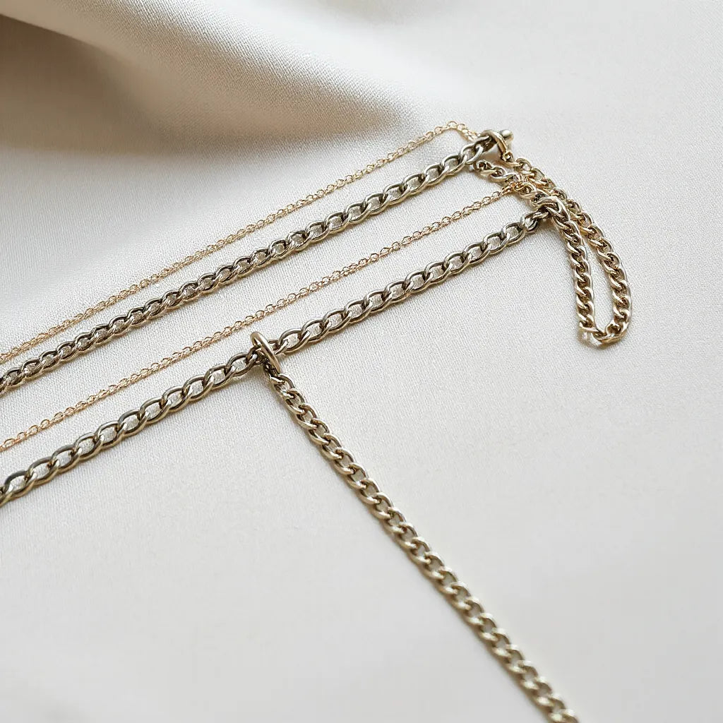 Assorted Franco chains with different thicknesses and finishes on a neutral studio surface