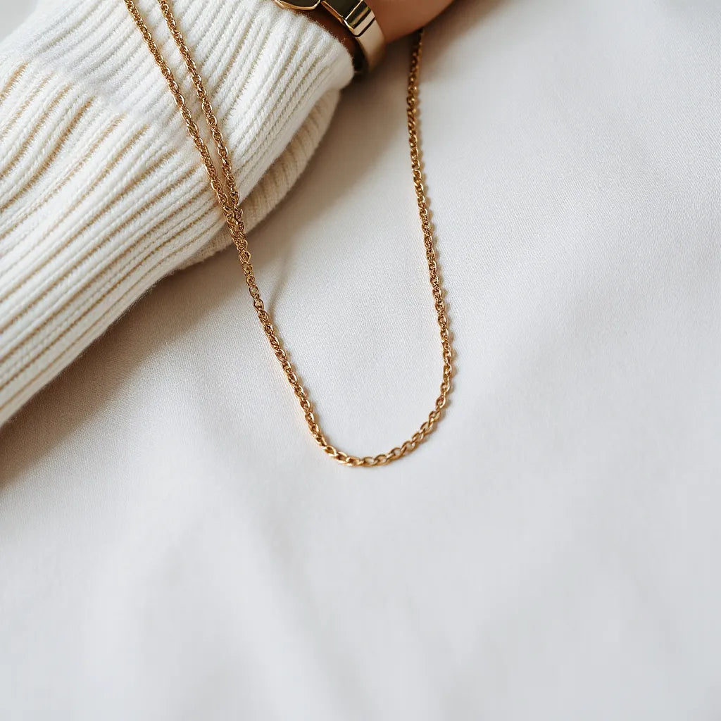 Figaro chain necklace styled with a soft sweater cuff in natural daylight